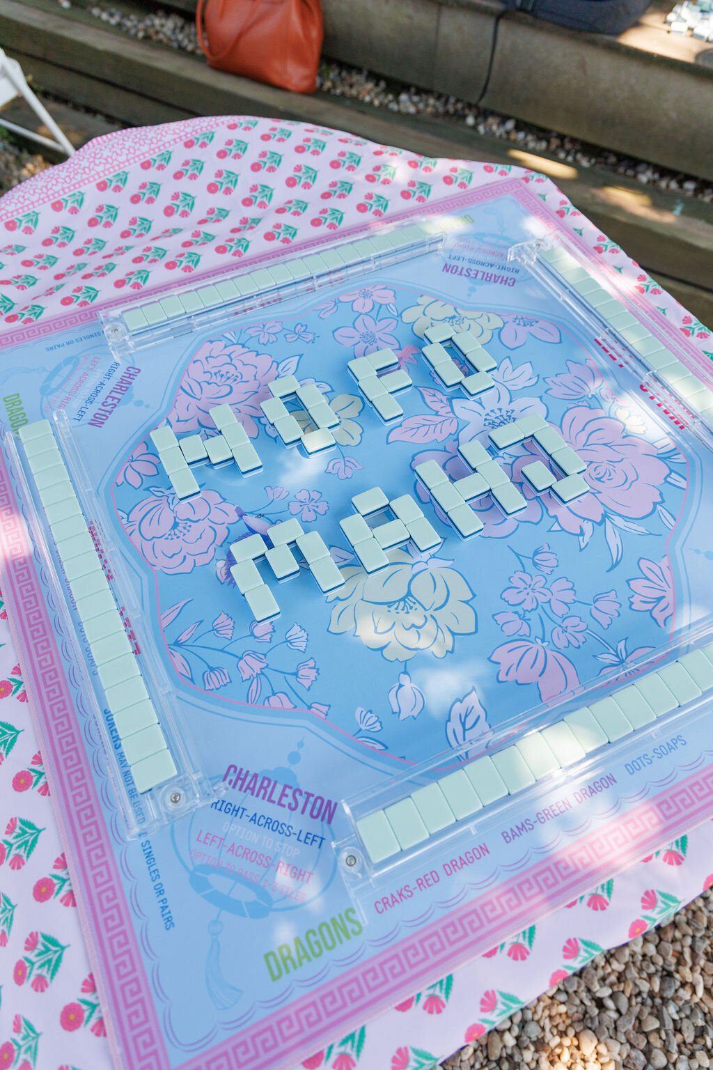 NoFo Mahj written in tiles on a blue mat.